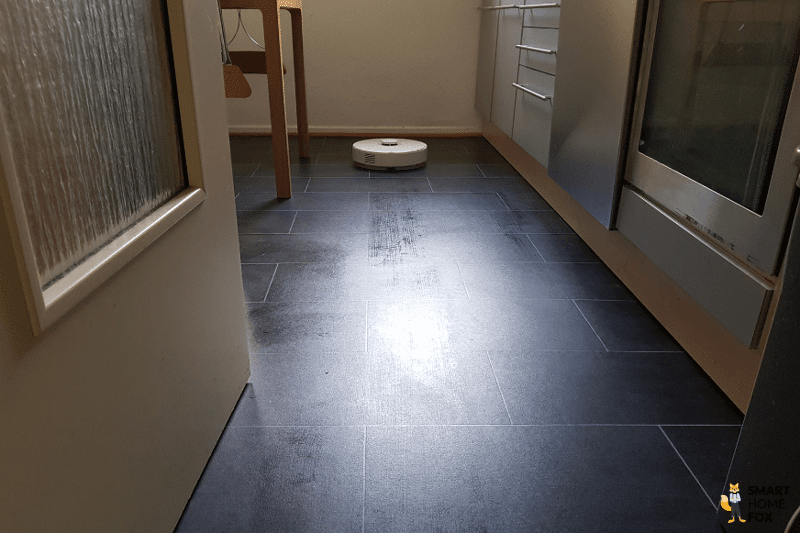 The Roborock Q7 Max mops the floor in the kitchen.